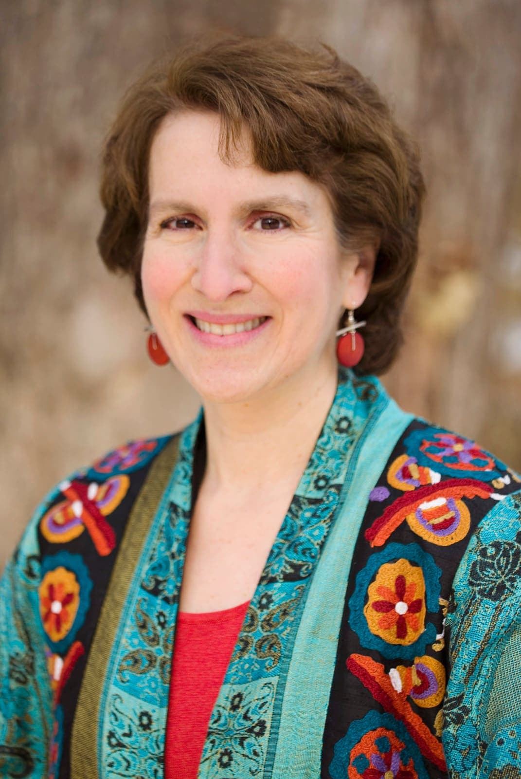 Joanne Fagerstrom, PT, CFP, smiling in a teal embroidered jacket