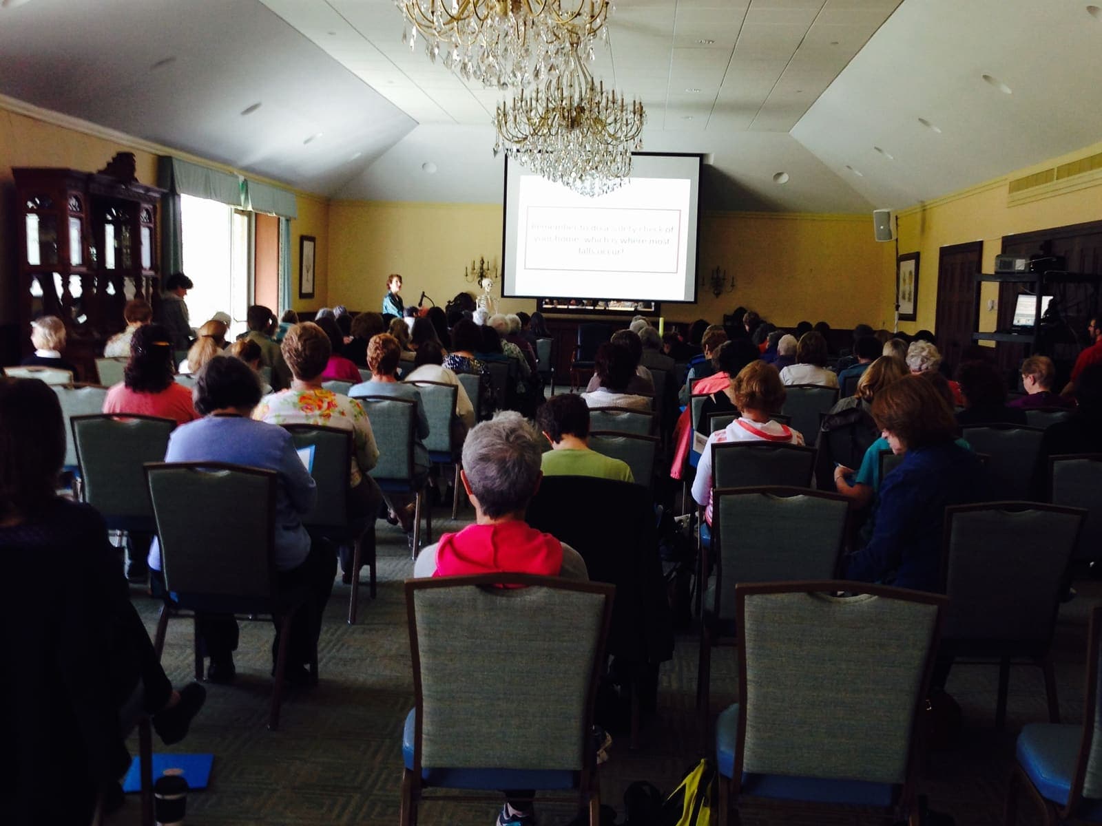 A full room of attendees watching Joanne present a bone health workshop